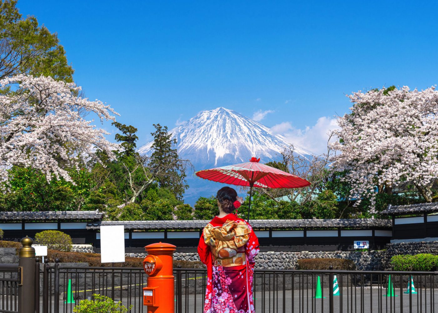 Asian woman wearing japanese traditional kimono at Fuji mountain and cherry blossom in spring, Fujinomiya in Japan.